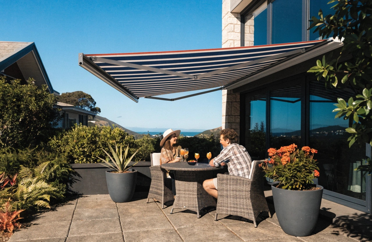 Motorised retractable awning over coastal Newcastle home patio with family entertaining outdoors